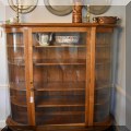 F22. Antique bowed glass and oak display shelves. 